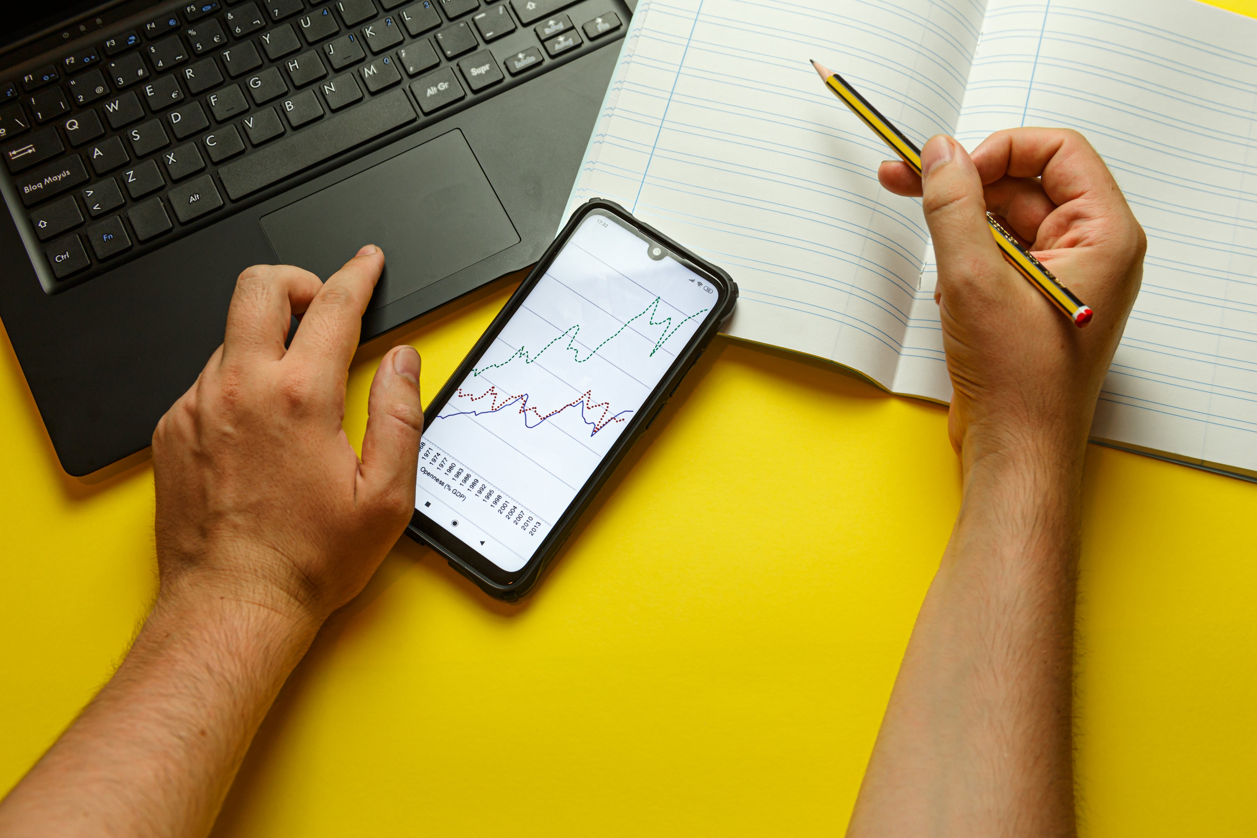 office-desk-with-hands-taking-notes